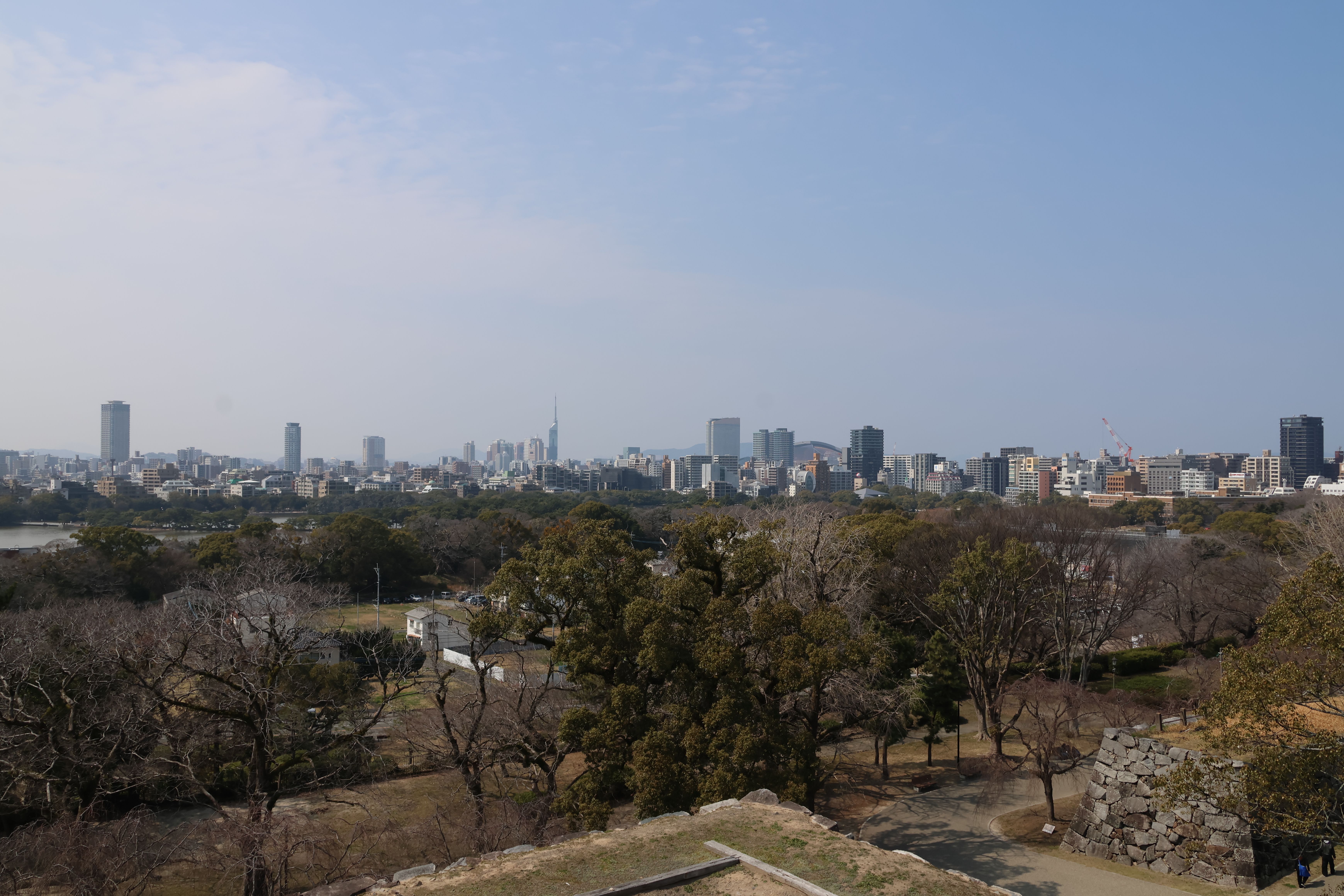 Fukuoka city skyline viewed from Fukuoka Castle ruins with Ohori Park in the foreground