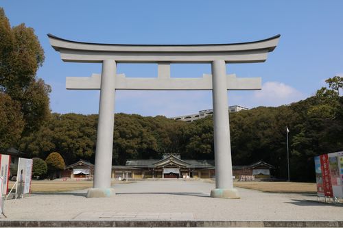 Free Peaceful scene of a large Torii gate at a serene Japanese shrine, surrounded by lush woods. Stock Photo