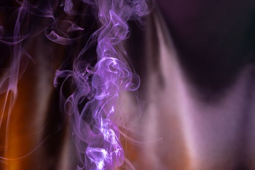 Free Dynamic purple smoke swirls create an ethereal abstract background. Stock Photo