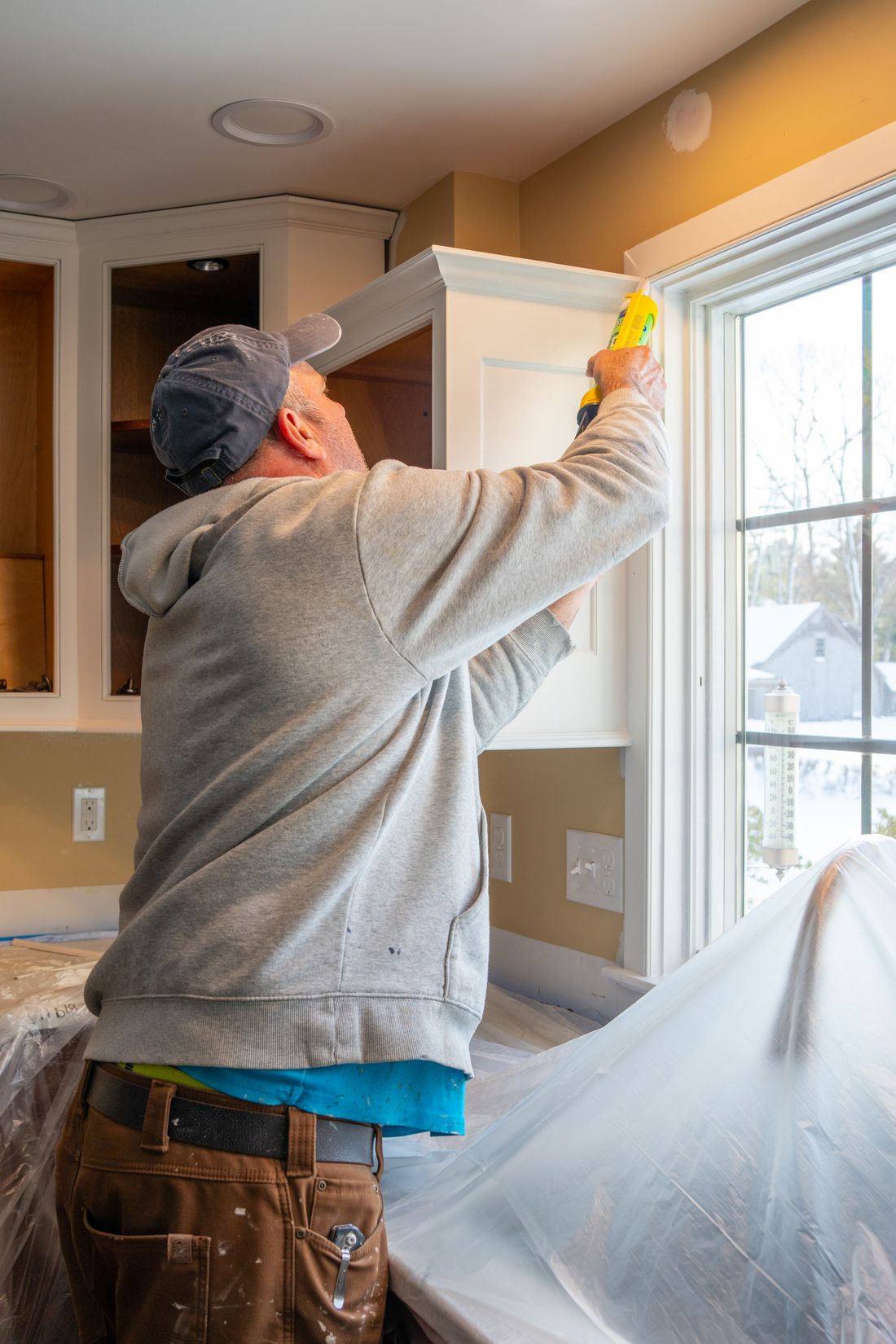 Johnny's Remodeling carpenter fitting kitchen cabinetry