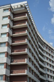 Geometric apartment building with clear blue sky backdrop, showcasing urban architecture.