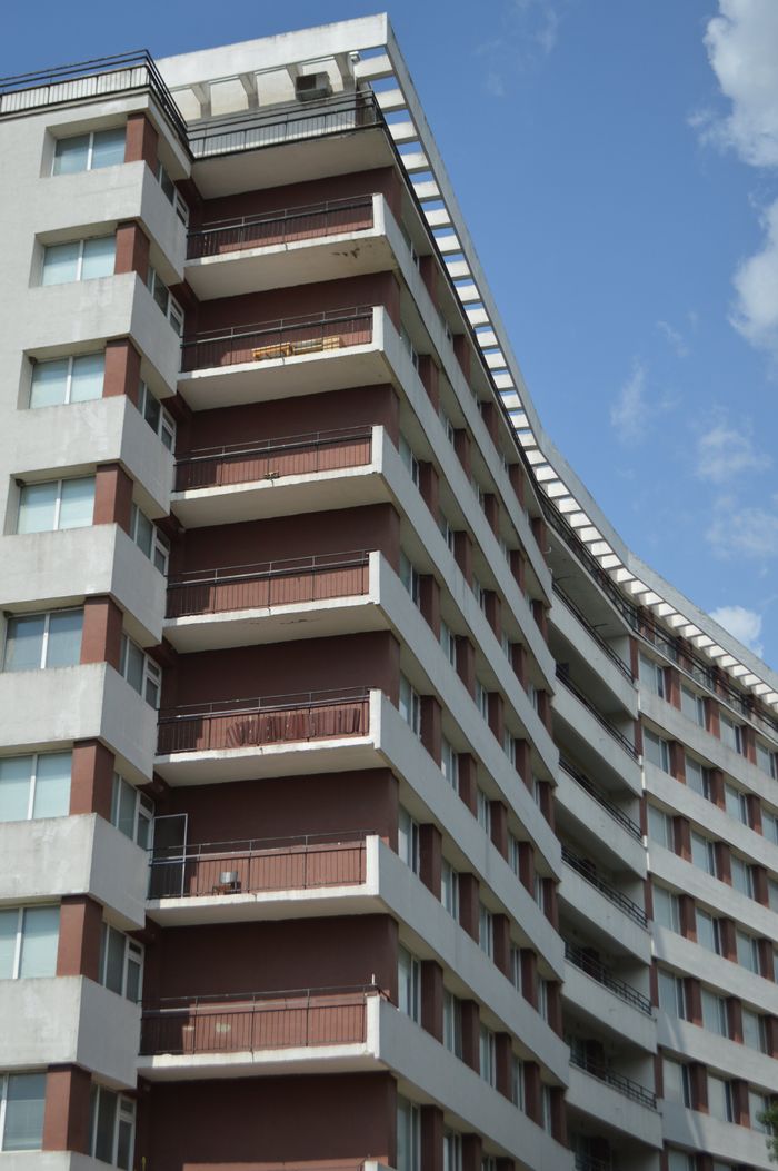 Geometric apartment building against a clear blue sky — photo by Valeria Drozdova on Pexels