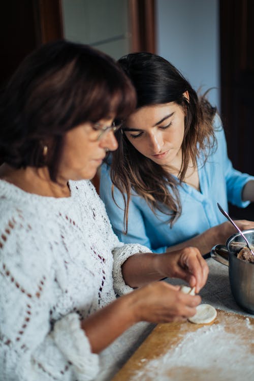 Free Woman in White Knitted Sweater Holding Dough Stock Photo