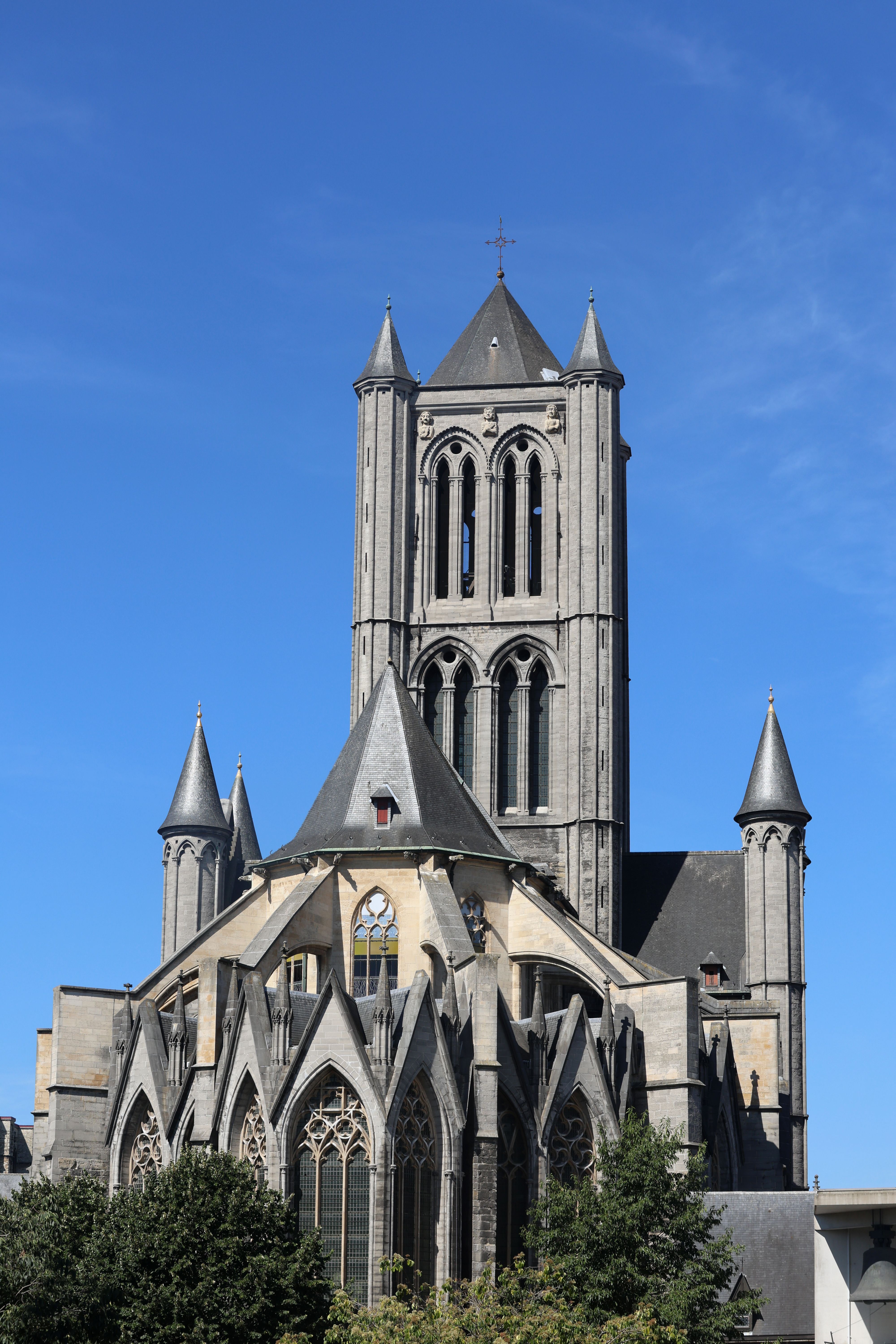 Stunning view of Saint Nicholas' Church under a clear blue sky in Gent, Belgium.