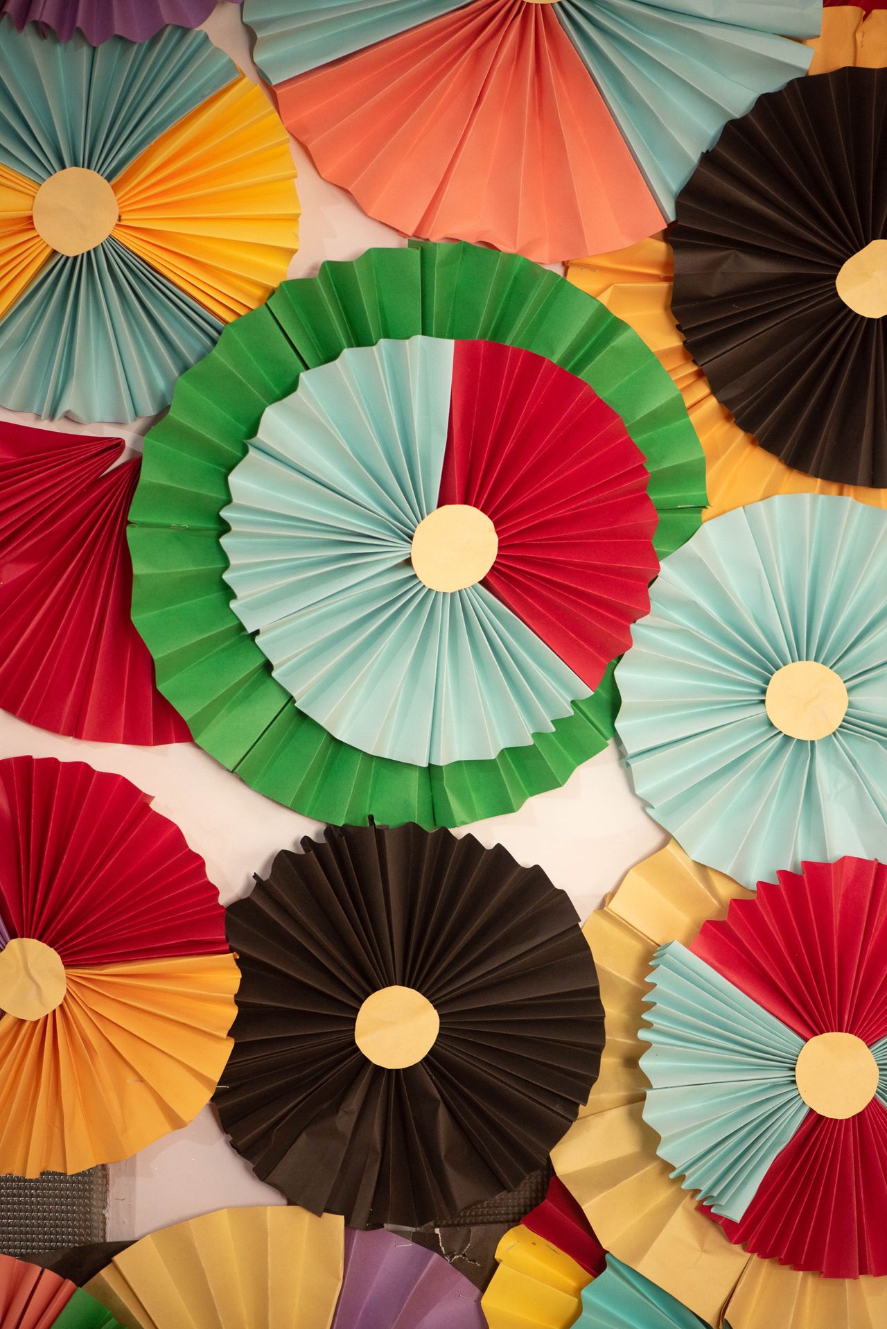 patriotic-paper-fan-wall Colorful paper fan decorations arranged for a party