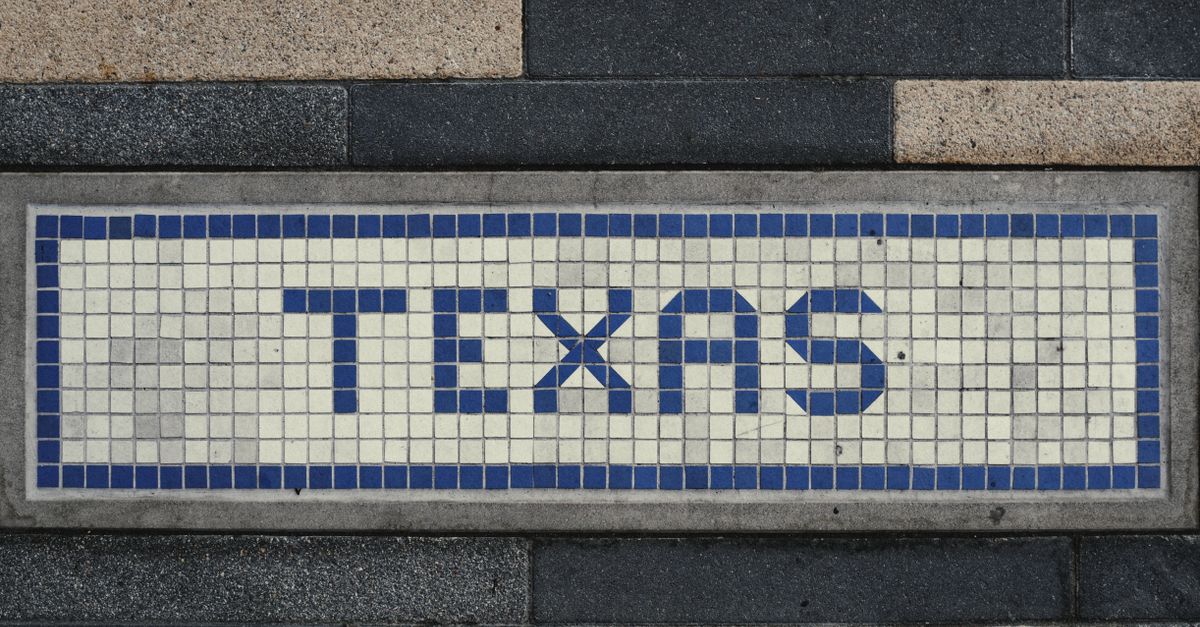Unique mosaic tile artwork spelling 'Texas' on a sidewalk in Houston, TX.