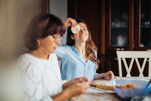 Mother and daughter bonding over making pelmeni in a cozy kitchen setting.