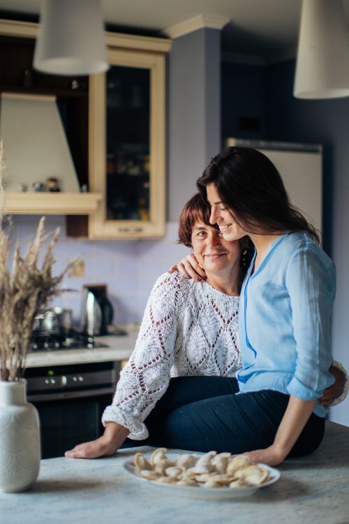 Free A loving mother and daughter share a moment while making traditional pelmeni in a warm, cozy kitchen. Stock Photo