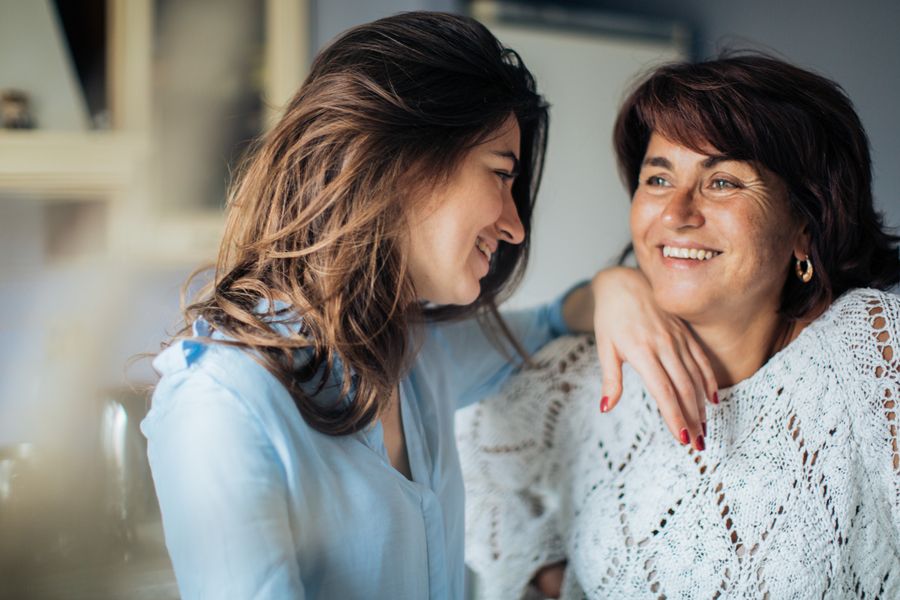 Two women smiling warmly at each other