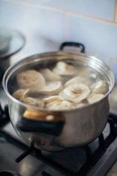 A pot of dumplings boiling on a stove, capturing the essence of homemade cooking.