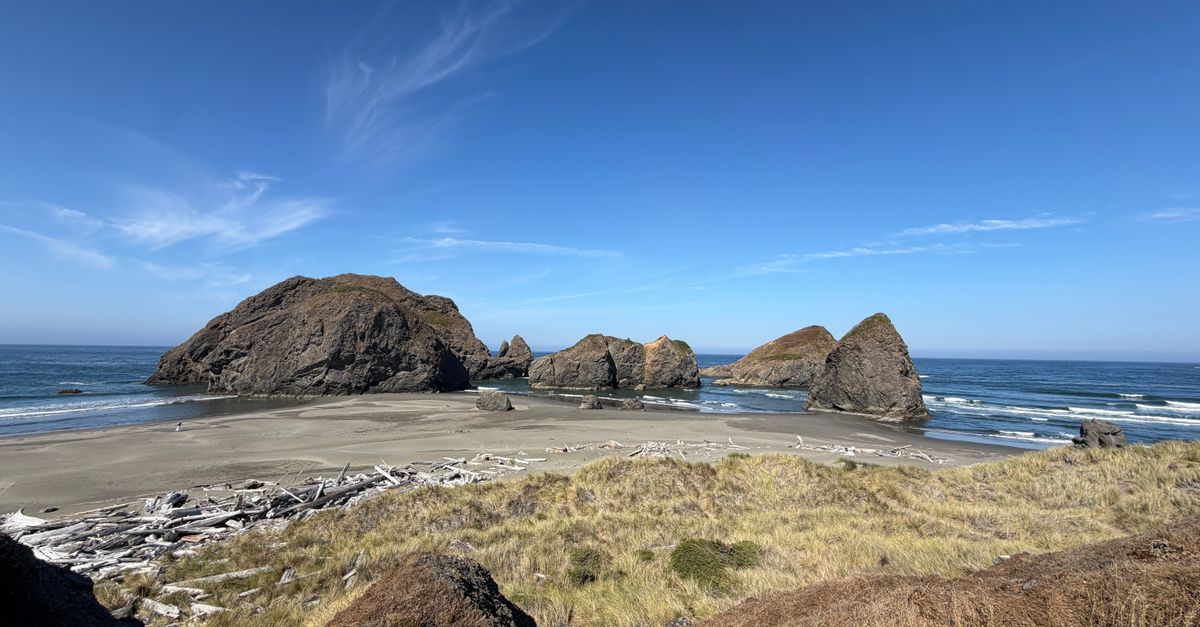 Beautiful view of Bandon Beach with distinct rock formations under a clear blue sky.
