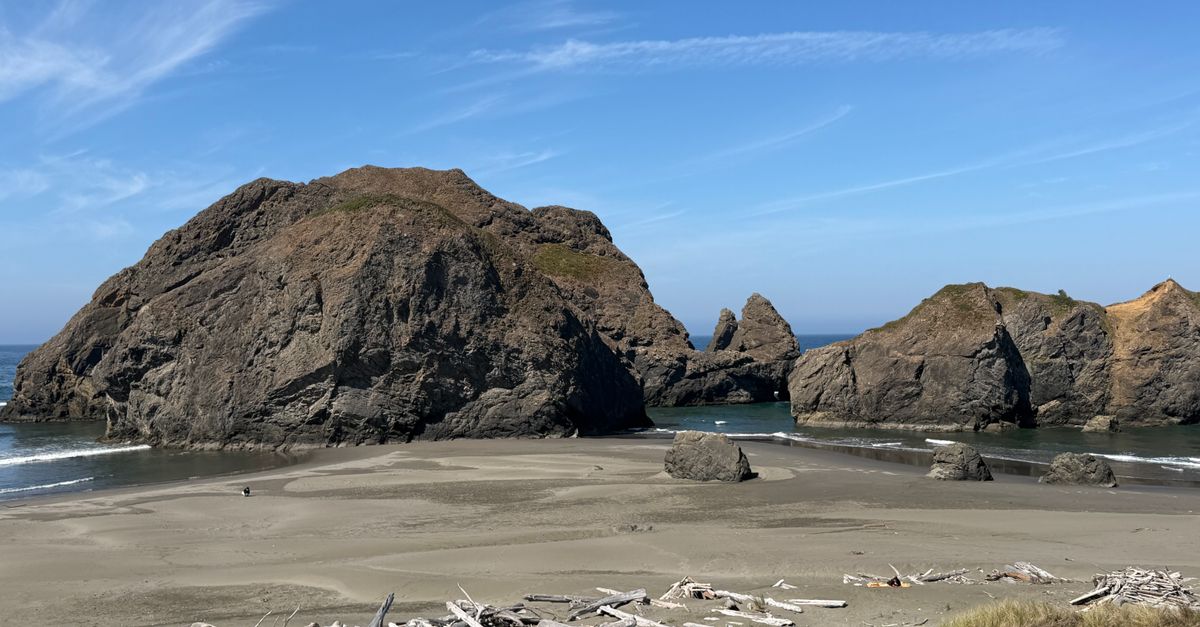 Stunning view of rocky formations along the Oregon coast under a clear blue sky.