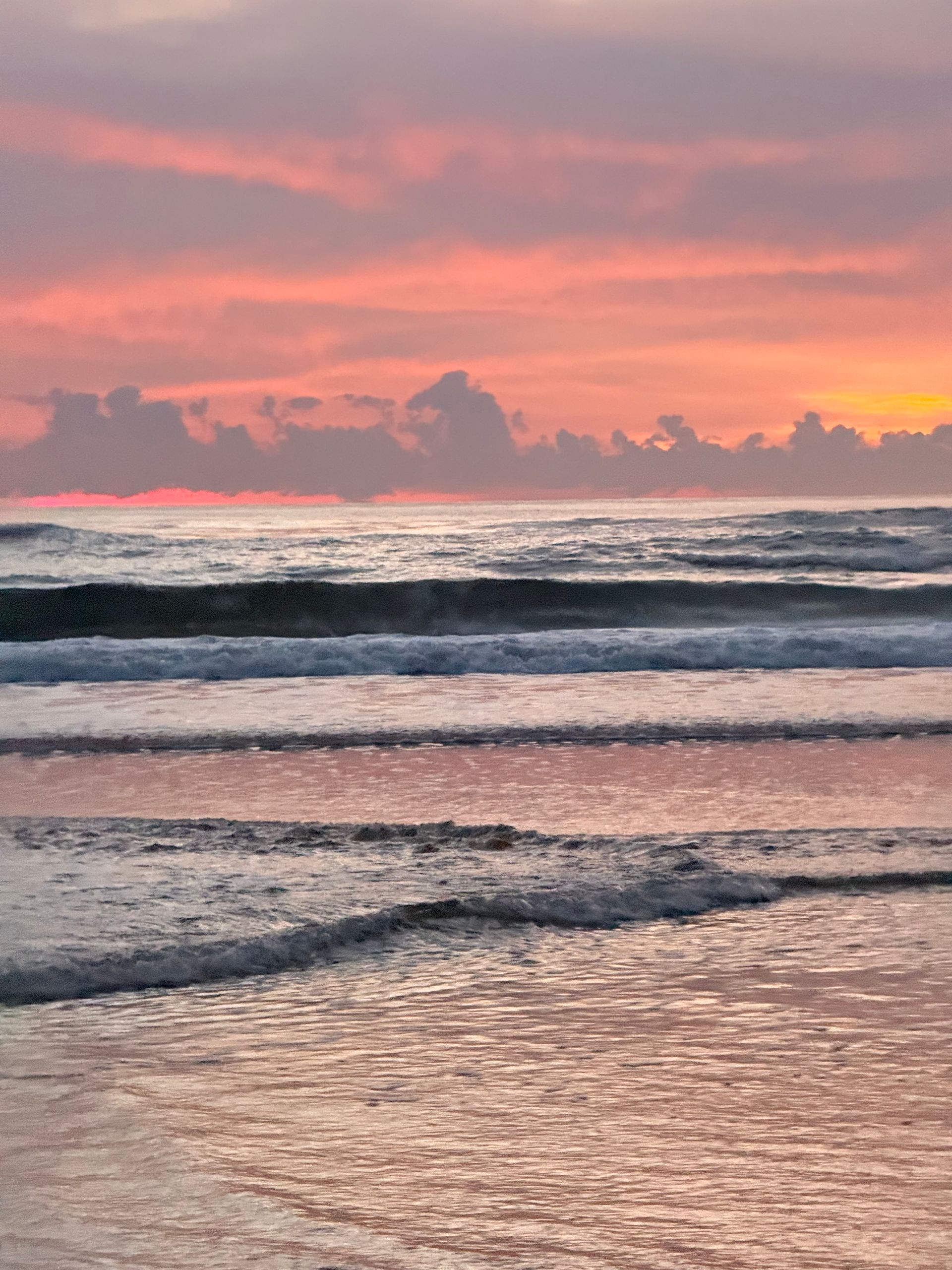 Sunrise breaking over ocean waves