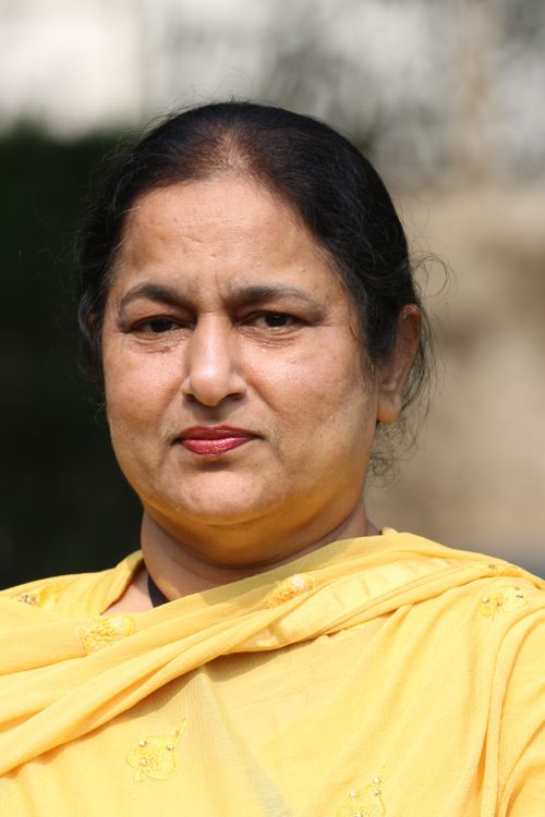 Free Close-up portrait of a woman outdoors, wearing a yellow sari. Stock Photo