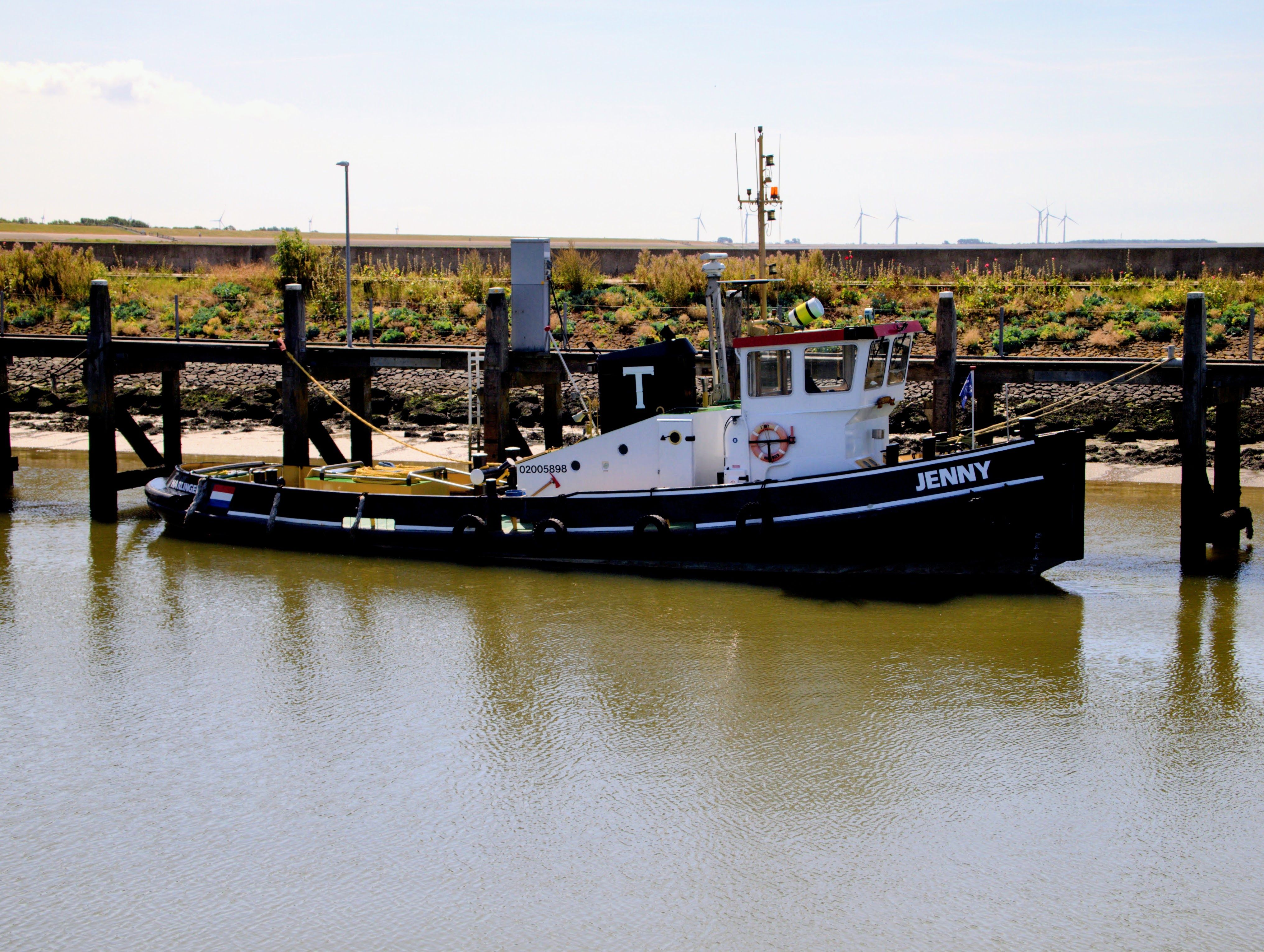 Tugboat Jenny docked in Harlingen, Friesland, captures the charm of Dutch maritime life.
