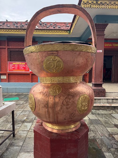Free Detailed view of a large brass Kalash with Hindu symbols at a Shiva Temple in Pokhara, Nepal. Stock Photo