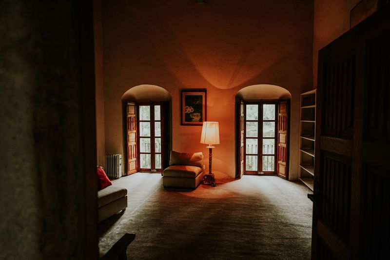A warm and inviting rustic living room with vintage decor and cozy lighting.