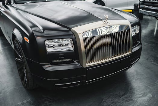 一辆黑色豪华汽车的特写，展现了其标志性格栅与引擎盖设计，凸显出优雅与精致