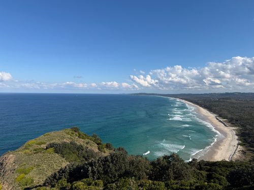 Free Stunning aerial photo of Byron Bay coastline with lush greenery and expansive ocean under a clear blue sky. Stock Photo