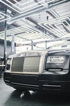 Close-up of a Rolls-Royce showcasing elegant design at a modern car exhibition.