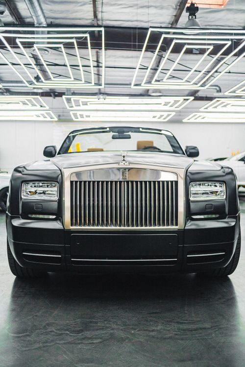 Free Front view of a classic luxury Rolls-Royce car in a modern indoor exhibition. Stock Photo