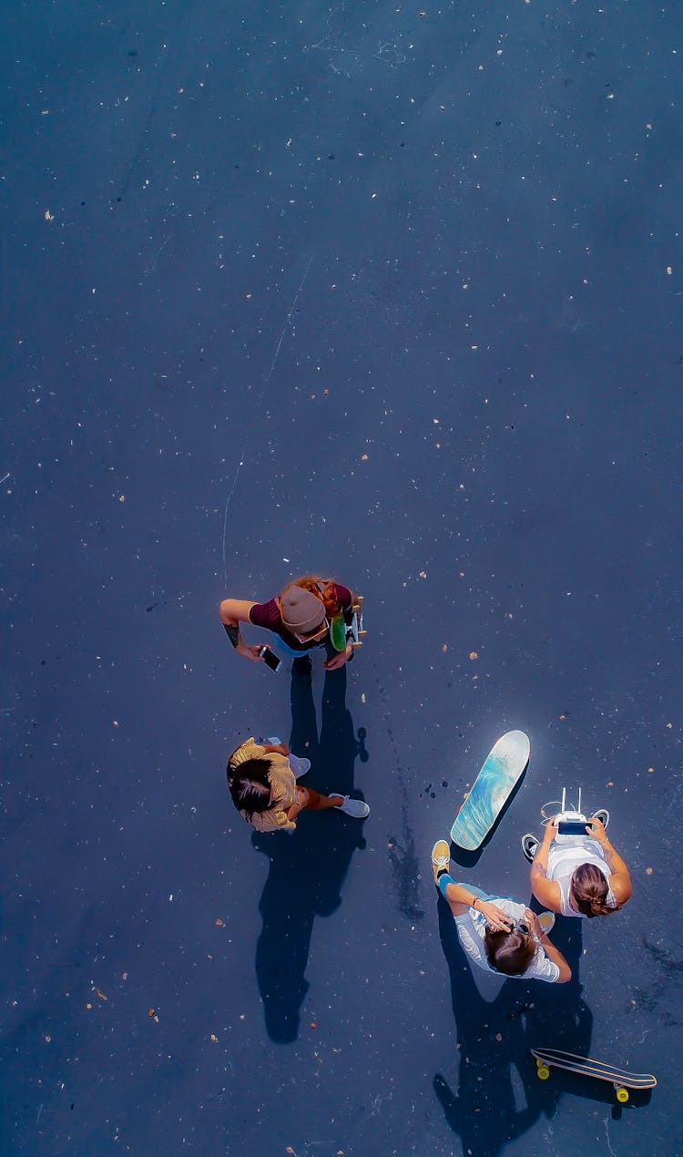 Aerial Shot Of Group Of Friends With Skateboards