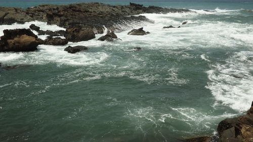 Free Stunning rocky coastline with waves crashing against jagged rocks, showcasing nature's raw power. Stock Photo