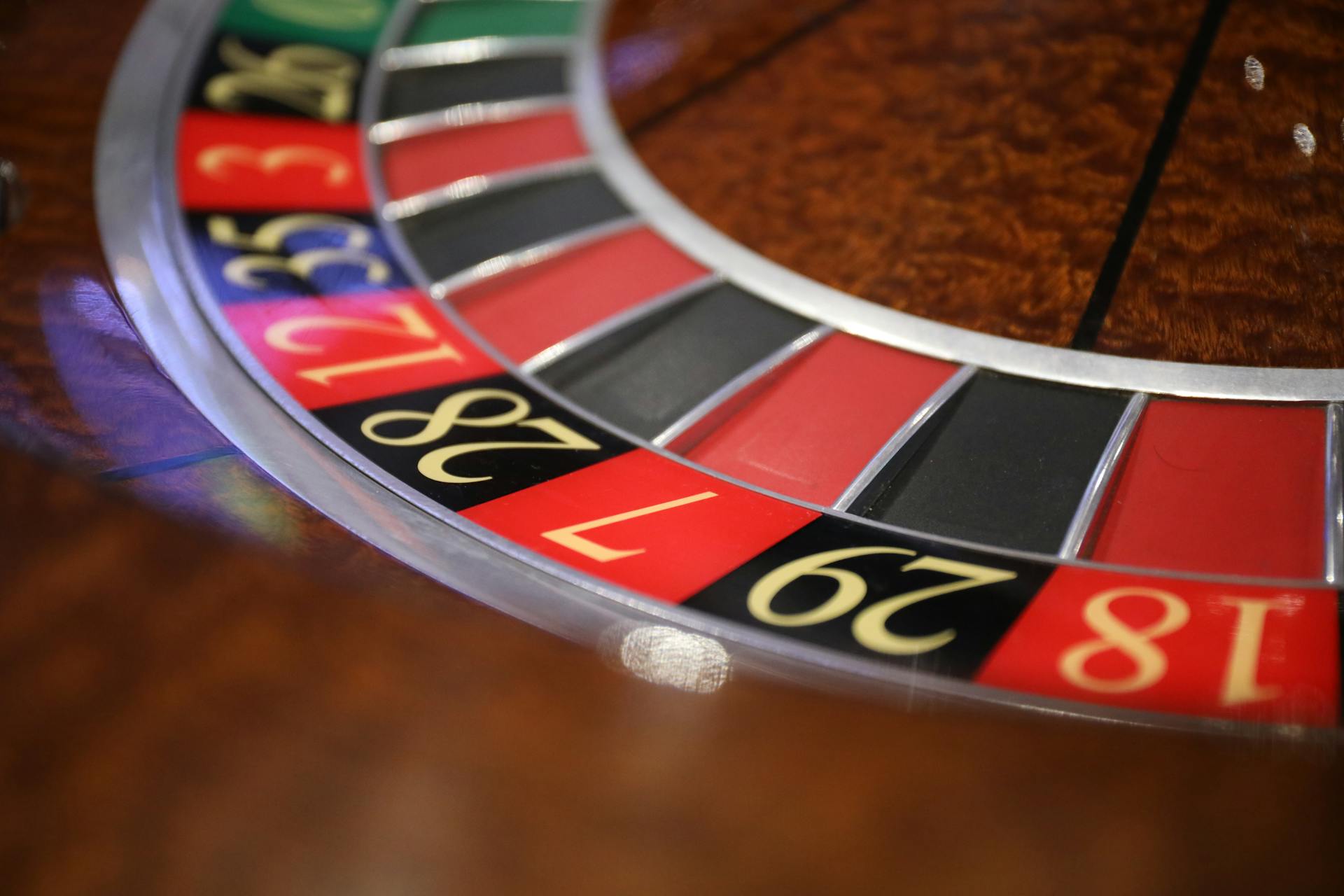 A detailed closeup of a roulette table displaying numbers and colors in a casino setting.