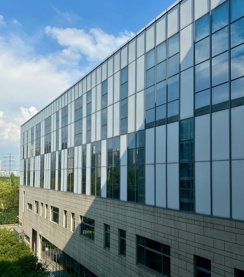 Free Contemporary office building with glass facade under blue skies in Suzhou, Jiangsu. Stock Photo