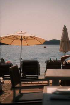 A tranquil beach scene in Lefkada, Greece, with sun loungers and umbrellas by the sea.