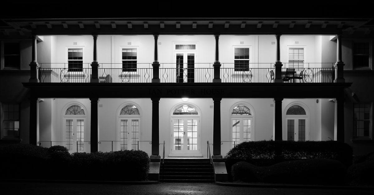 Elegant facade of Ian Potter House in Canberra lit up beautifully at night.