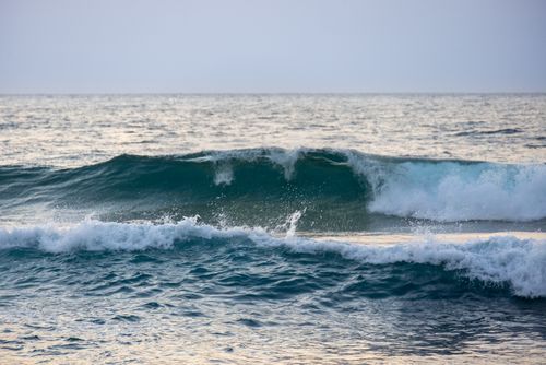 Free Dynamic ocean waves in the evening light create a serene and dramatic seascape view. Stock Photo