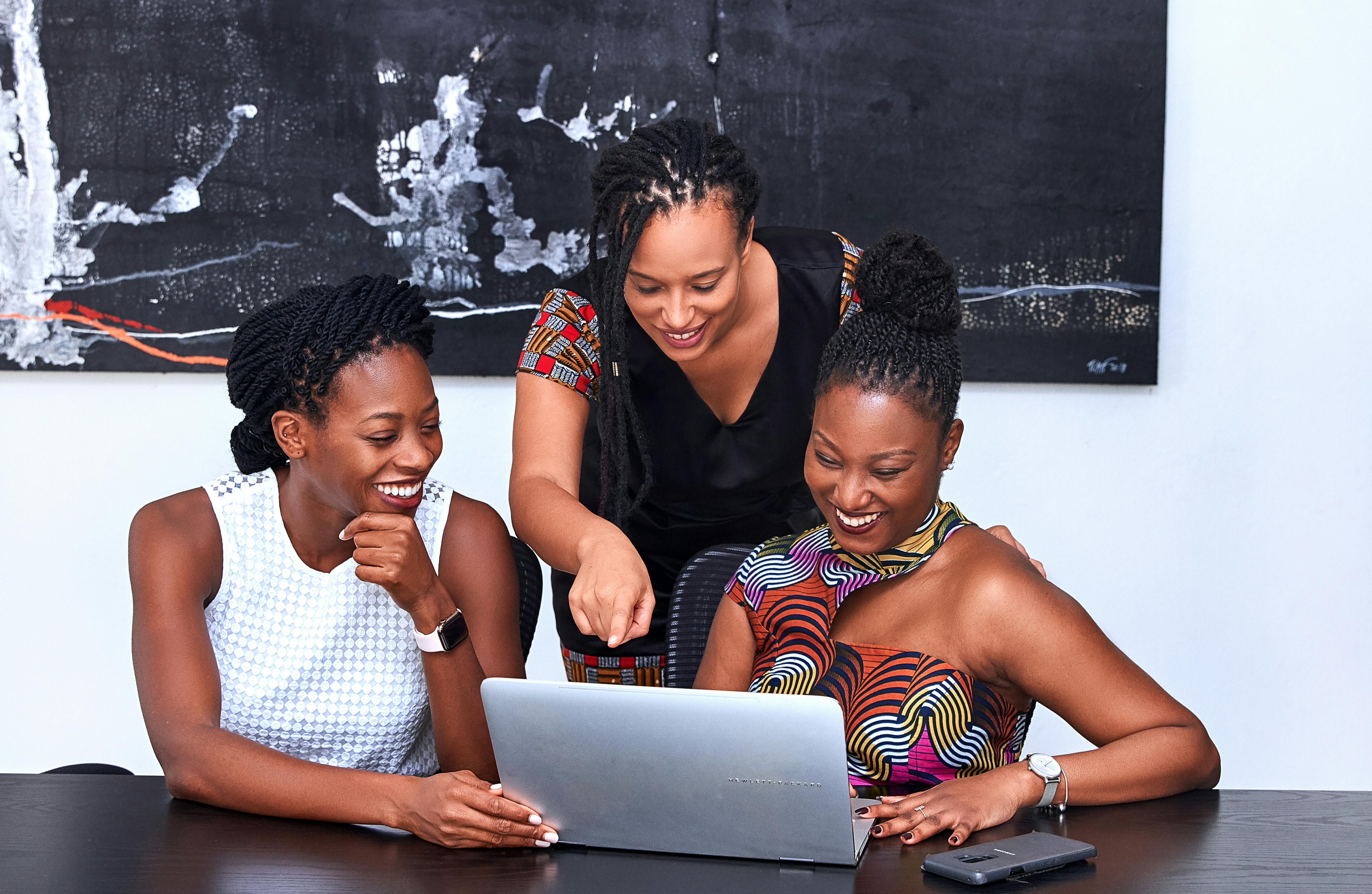 three women looking at the computer