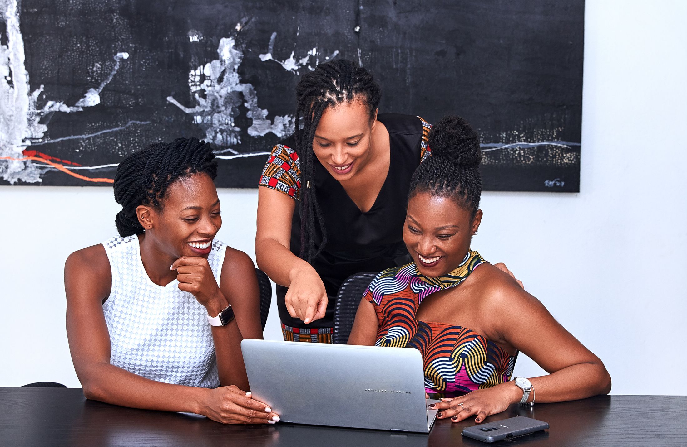 African women collaborating around a laptop during a learning session