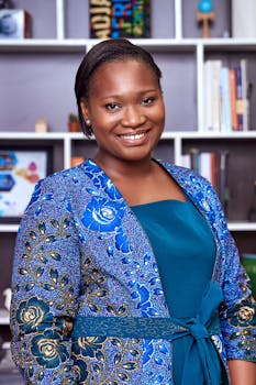 Portrait of a smiling businesswoman in a colorful blue outfit, exuding confidence.