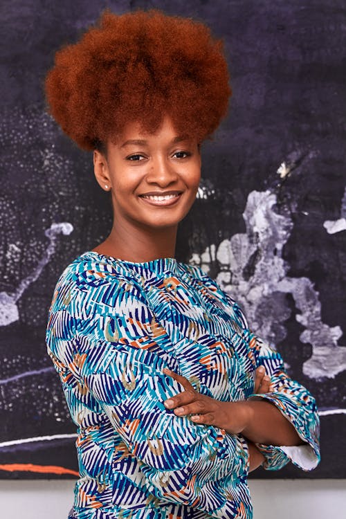 Woman in Blue and White Floral Top Smiling