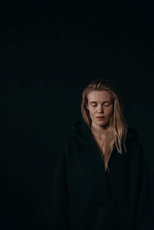 Free Artistic portrait of a woman with closed eyes on a dark background, conveying serenity and introspection. Stock Photo