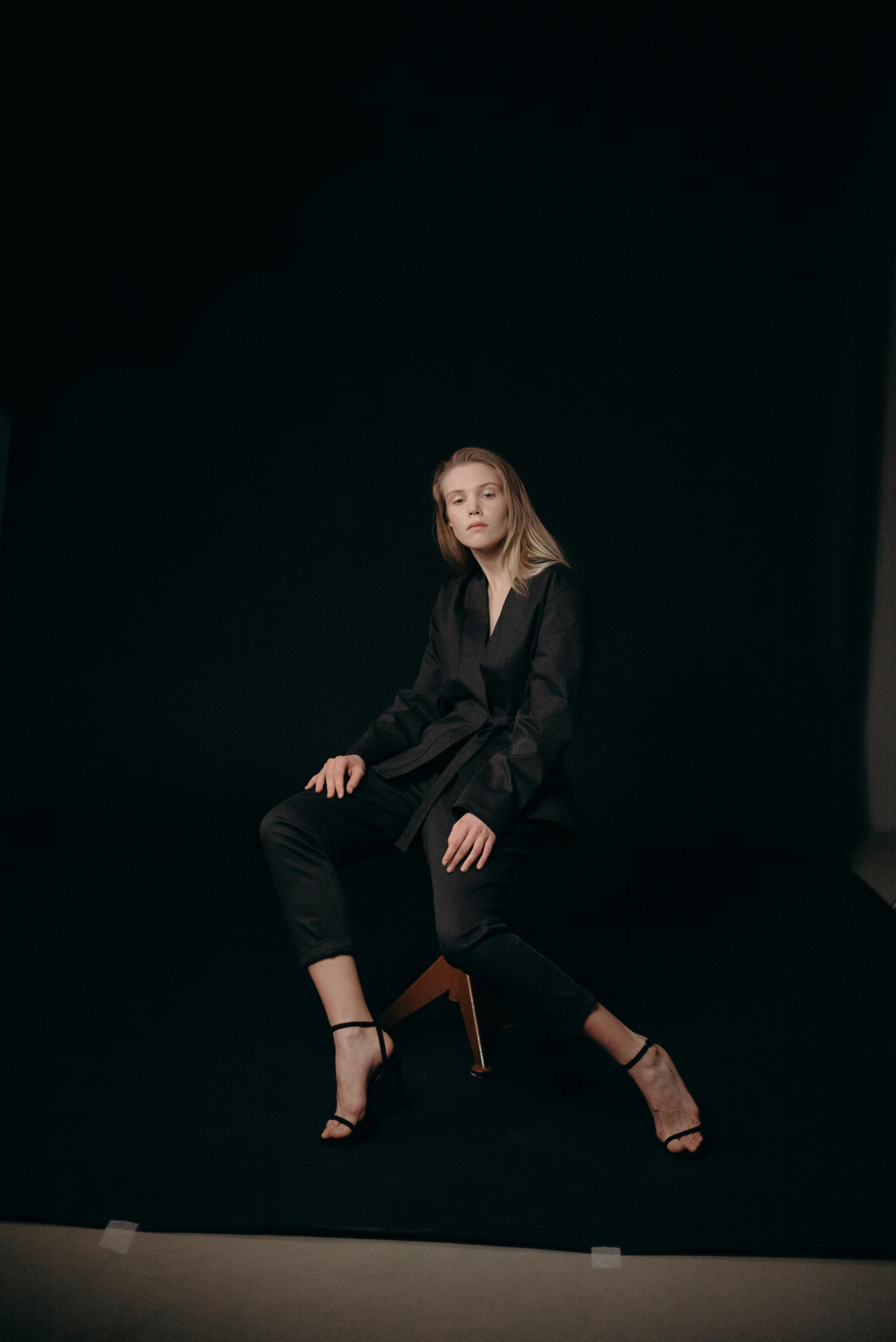 Woman in Black Blazer and Black Pants Sitting on Stool · Free Stock Photo