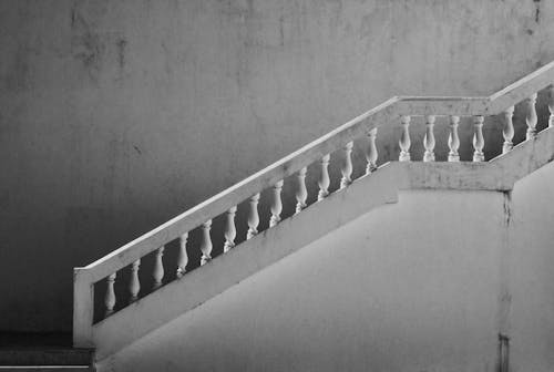Grayscale Photo Of Concrete Staircase With Railings
