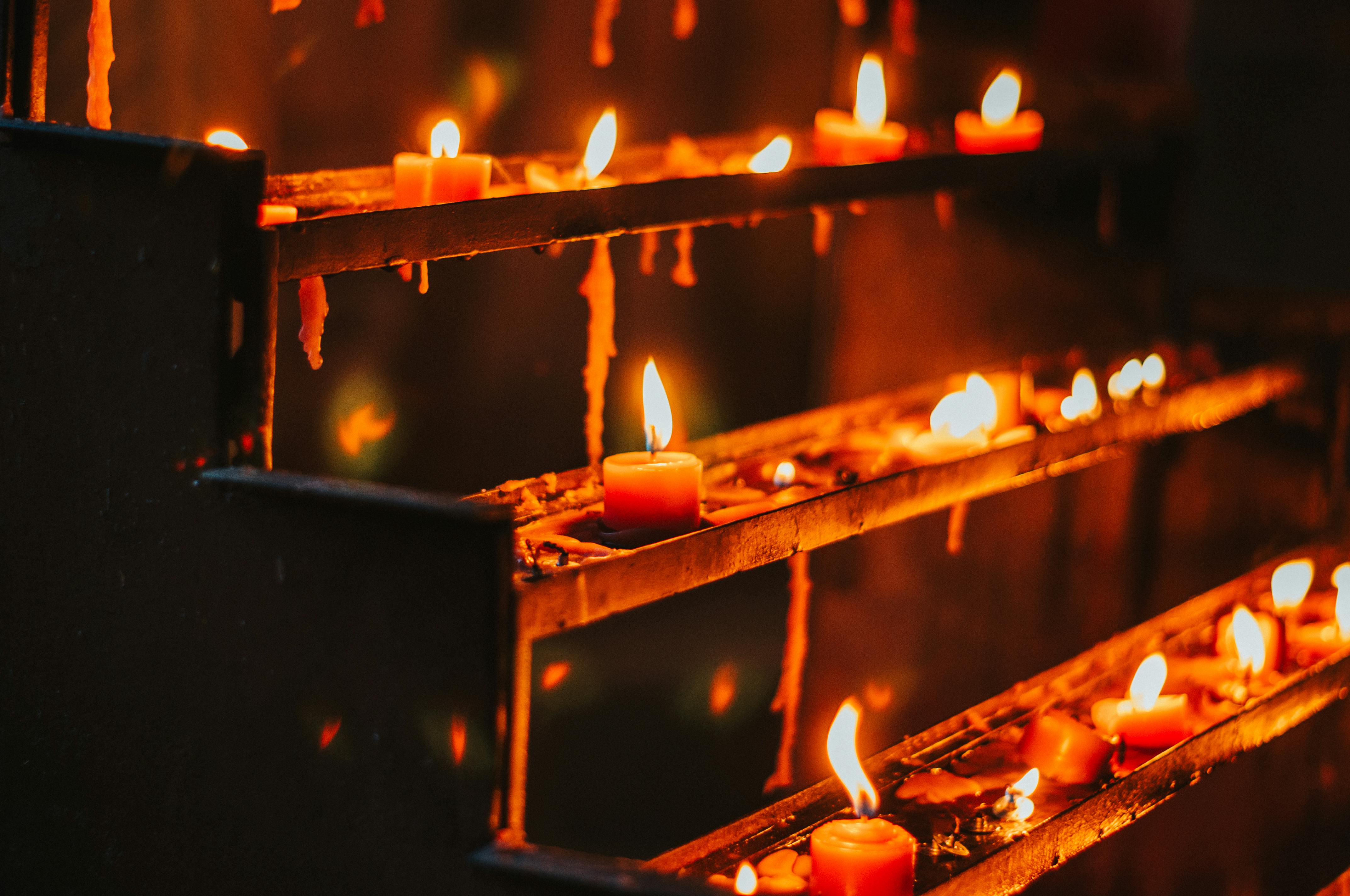 lighted candles on rack