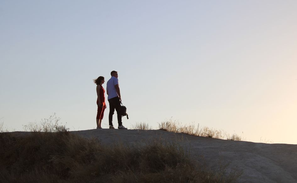 couple hiking with dog in mountain landscape
