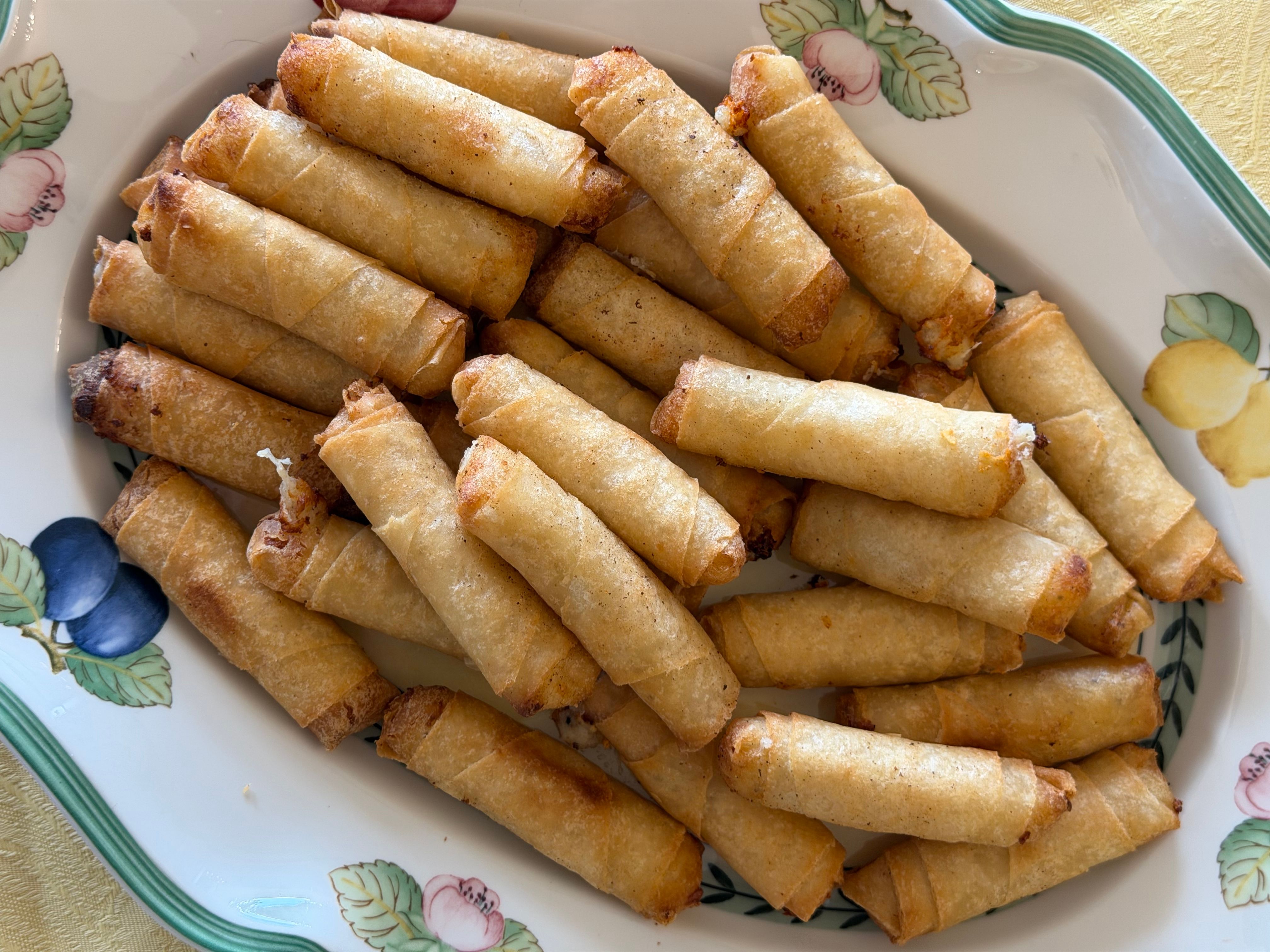Golden fried vegetarian spring rolls on a plate