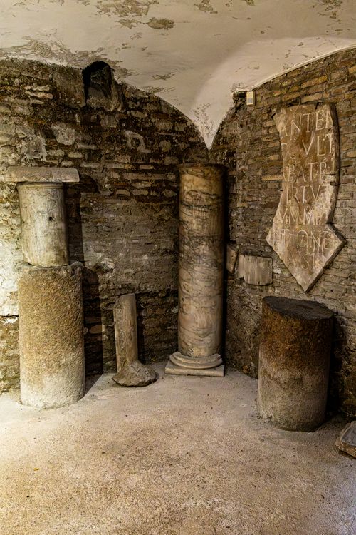 Free Intriguing view of ancient Roman columns and inscriptions in a historic underground room. Stock Photo