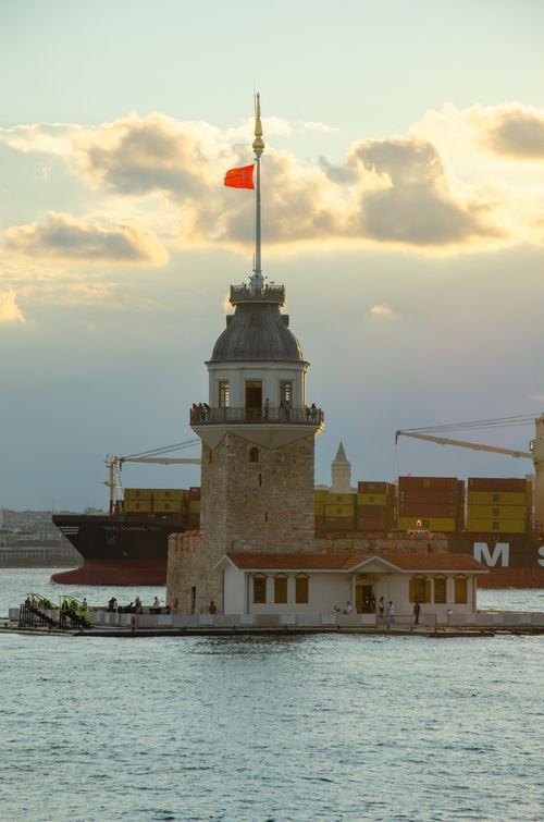 Free Scenic view of Kız Kulesi and cargo ship during a beautiful Istanbul sunset. Stock Photo