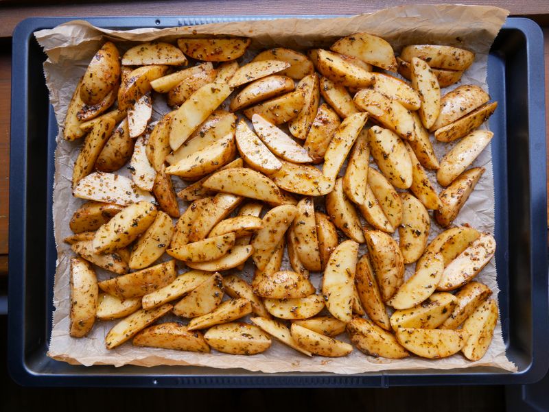A tray of roasted potato wedges — photo by Lena Netkach on Pexels