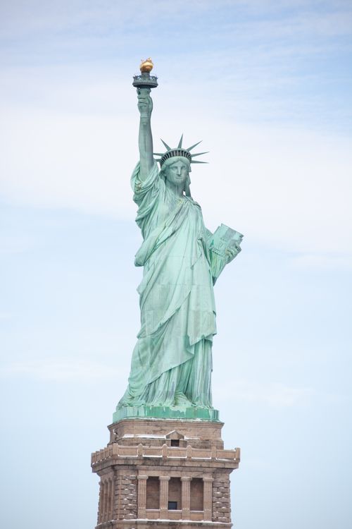 Free Iconic Statue of Liberty in New York City standing tall under clear skies, symbolizing freedom. Stock Photo