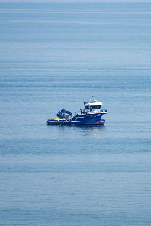 Free A solitary fishing boat in the tranquil Black Sea off the coast of Rize, Turkey. Stock Photo