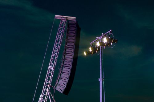 Free Image of a concert speaker and stage lighting setup under the night sky. Stock Photo