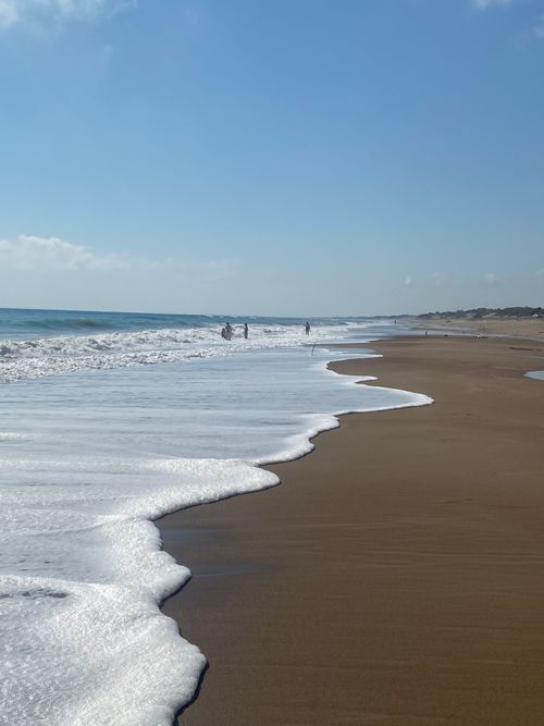 Free Beach scene with gentle waves at Kourouta Beach, perfect for a summer day in Greece. Stock Photo