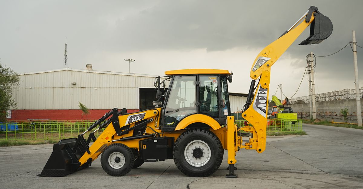 Side view of an ACE backhoe loader at a construction site in Faridabad, India.